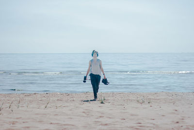 Full length of man on beach against sky