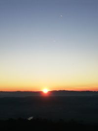 Scenic view of silhouette landscape against clear sky during sunset