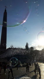 Aerial view of bubbles in city against sky