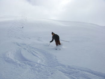 Man skiing on snow covered landscape