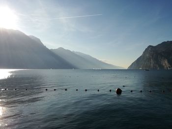 Scenic view of sea and mountains against sky