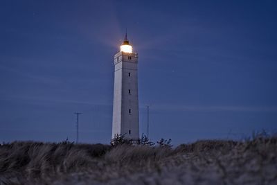 Lighthouse by sea against sky