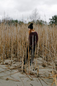 Rear view of man standing on field