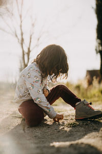 Girl sitting on road