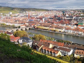 High angle view of townscape by river in city