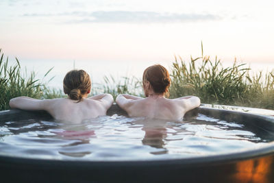 Portrait of happy family swimming in lake