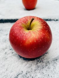 Apple on snow background