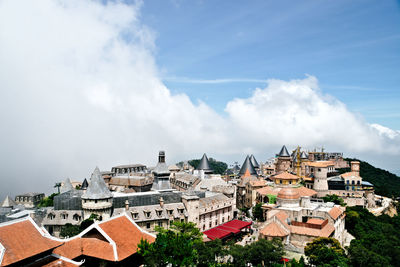 Buildings in town against sky