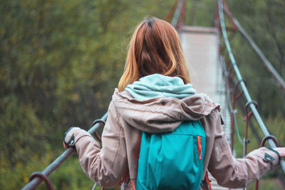 Rear view of woman holding umbrella