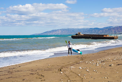 Man on beach against sky