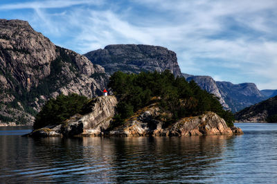 Rock formations by sea against sky