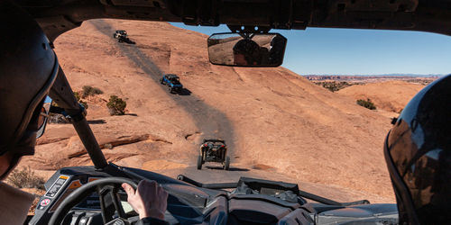 Full frame view of a 4x4 tour in rugged sandstone terrain on a trail called hell's revenge