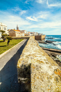 View of sea and buildings against sky