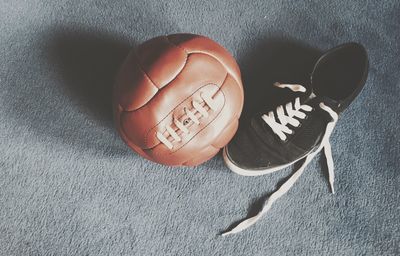 High angle view of soccer ball with shoe on carpet