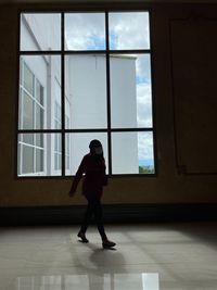 Full length of woman walking in building