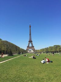 People at park against eiffel tower