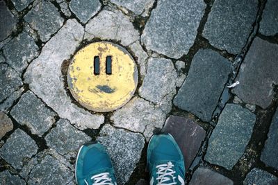 Low section of man standing on tiled floor