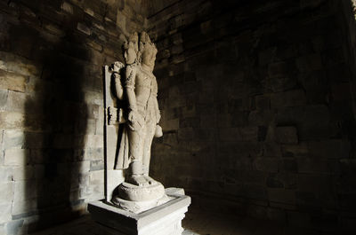 Statue against wall of building