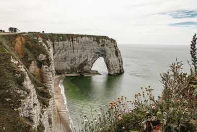 Rock formations by sea against sky