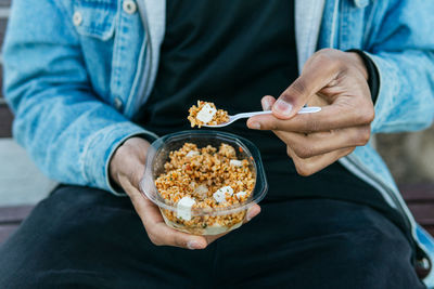 Midsection of man holding ice cream