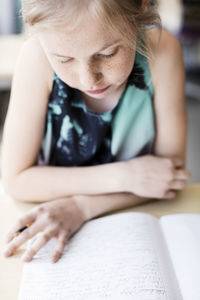 Student reading book in classroom