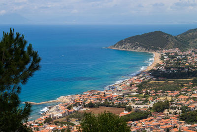 High angle view of townscape by sea against sky