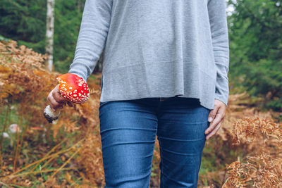 Midsection of woman holding mushroom