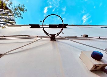 Low angle view of basketball hoop against blue sky