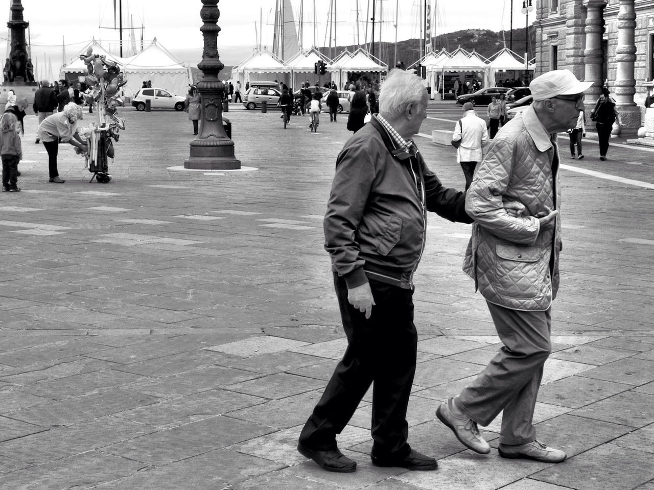 men, walking, lifestyles, person, full length, rear view, large group of people, casual clothing, leisure activity, street, city, built structure, city life, architecture, building exterior, day, incidental people, togetherness, boys