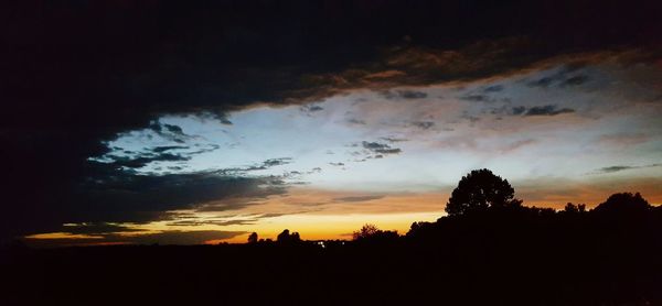 Silhouette of trees against sky at sunset