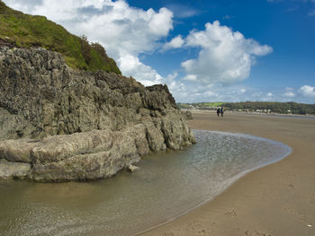 Rocks on beach against sky