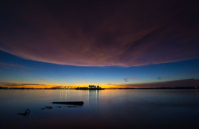 Scenic view of lake against sky during sunset