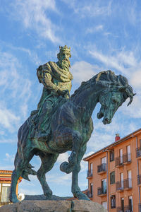 Low angle view of statue against cloudy sky