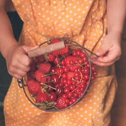 Close-up of woman holding strawberry