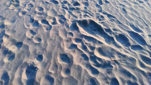 High angle view of footprints on sand