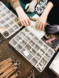 High angle view of woman making a customized fashion accessories. 