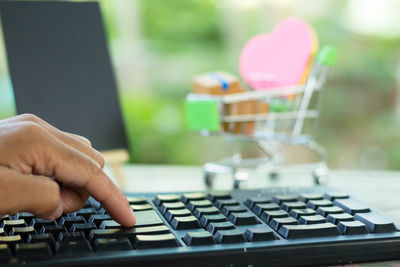 Close-up of person using laptop on table