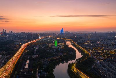 High angle view of buildings in city during sunset