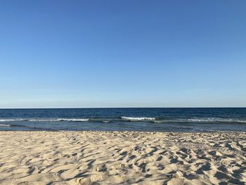 Scenic view of sea against clear blue sky