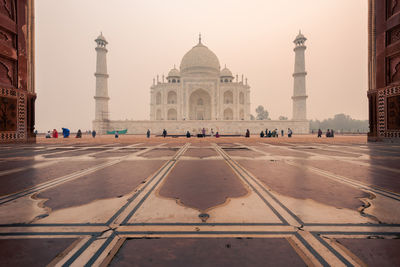 People in front of taj mahal during sunset
