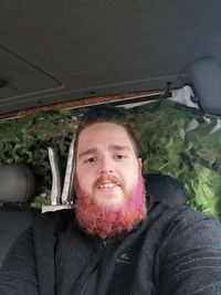 Portrait of smiling man in car