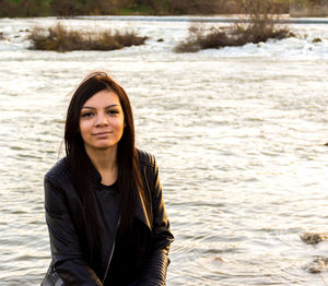 Portrait of smiling young woman at beach