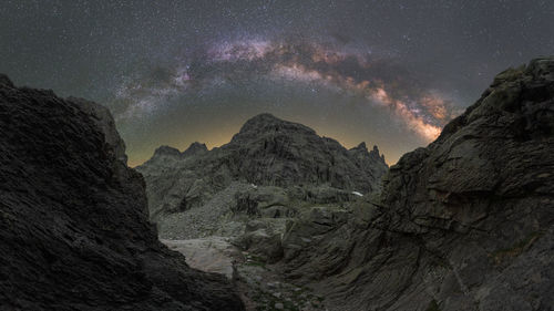 Scenic view of mountains against sky at night