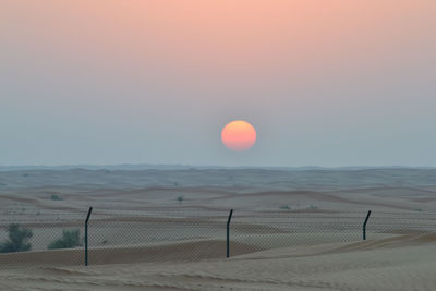 Scenic view of beach against sky during sunset