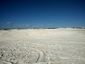 Scenic view of desert against blue sky