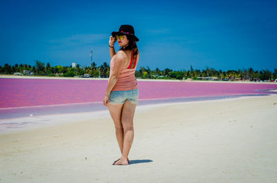 Full length of woman standing on beach