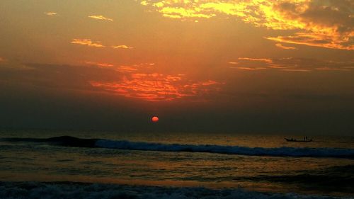 View of calm beach at sunset