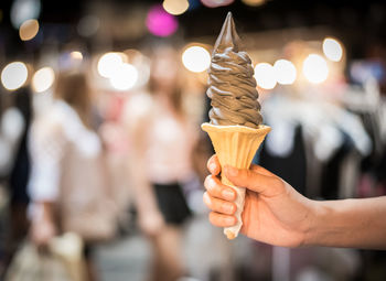 Close-up of hand holding ice cream cone