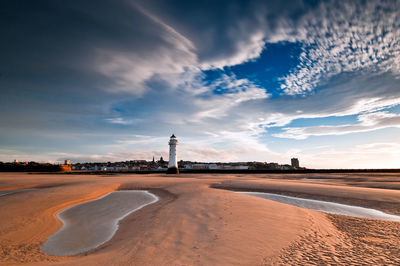 Scenic view of beach against sky during sunset