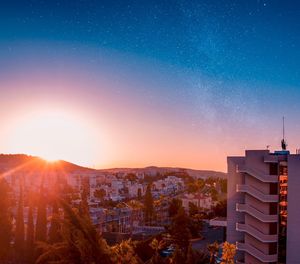 View of town against sky at night